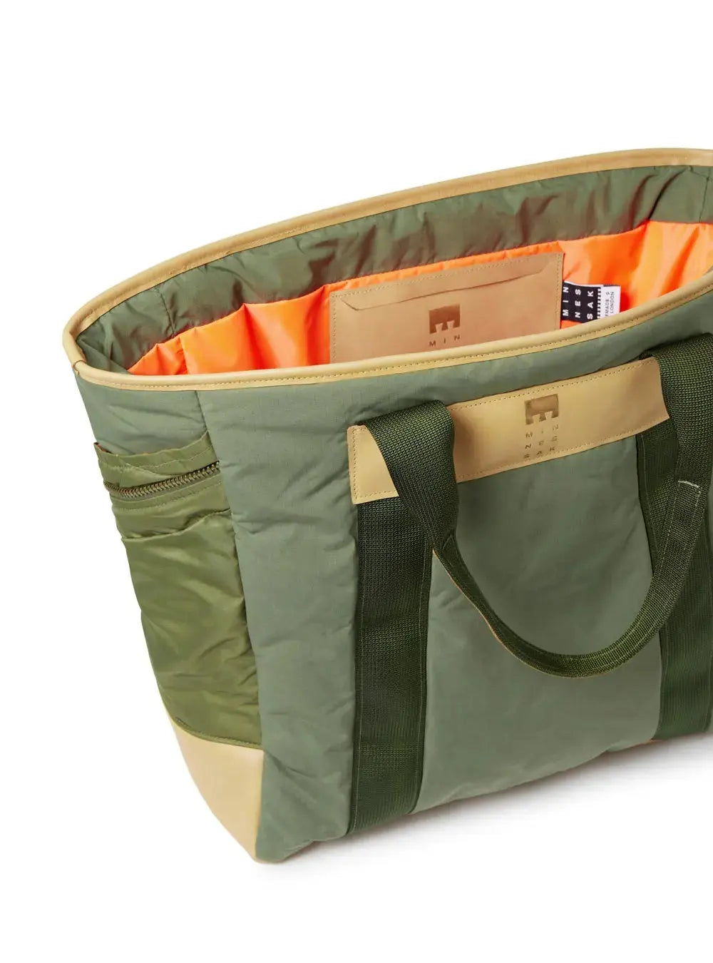 Green and beige tote bag with orange interior on a white background