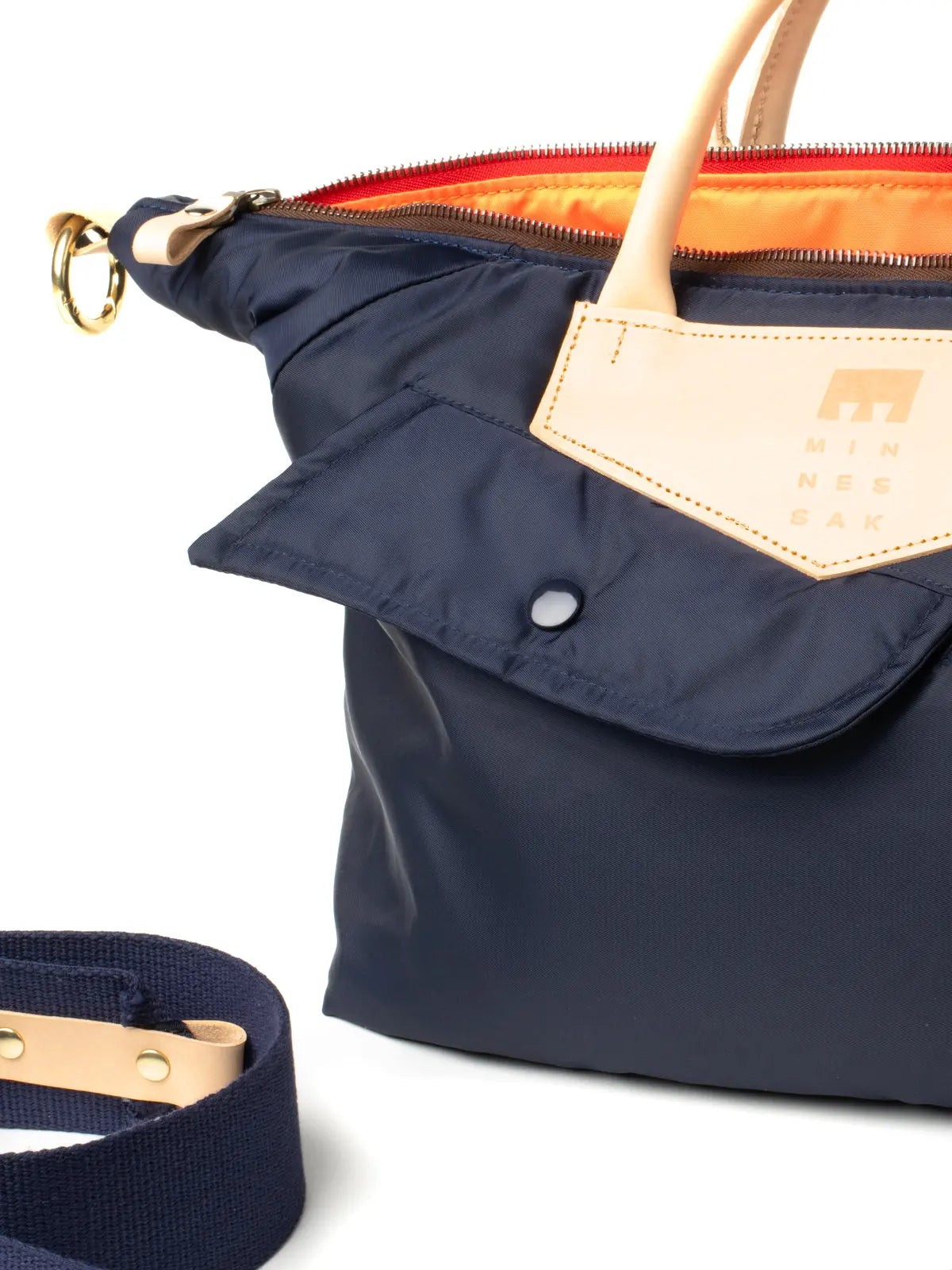 Navy blue handbag with beige accents on a white background