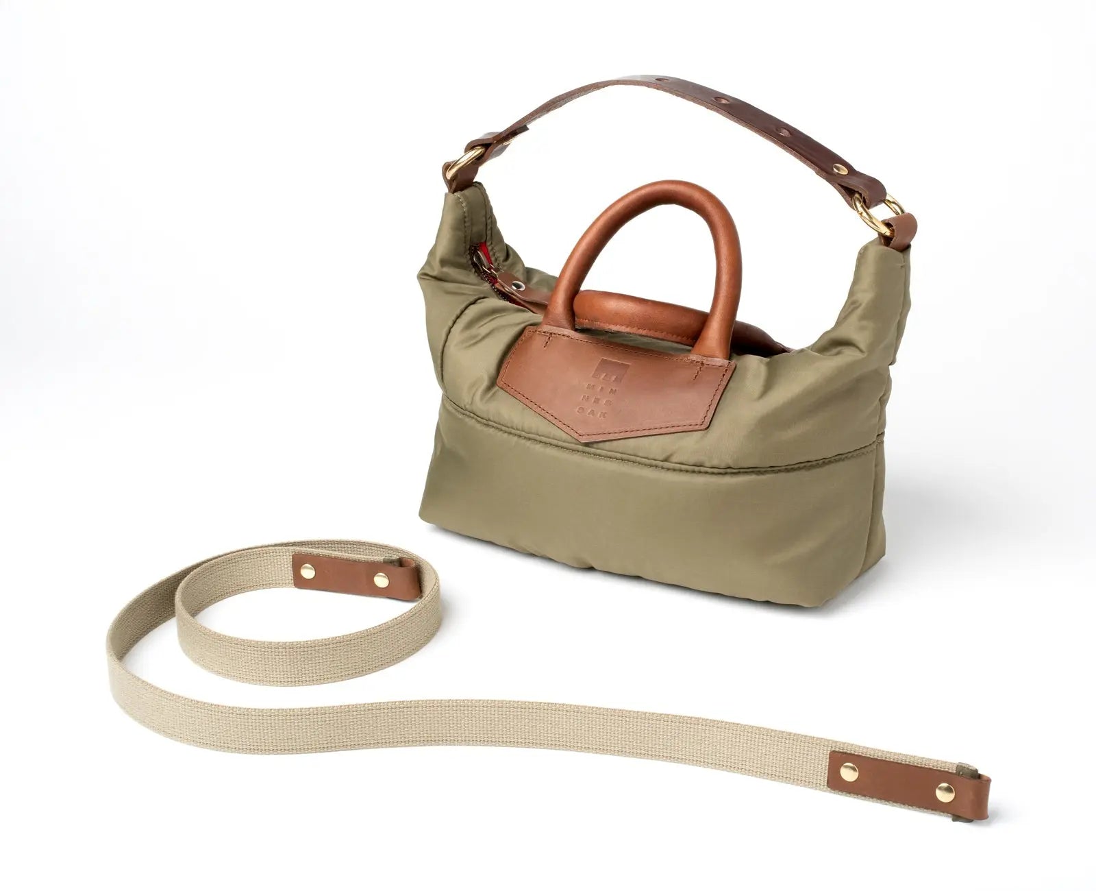Olive Khaki handbag with brown leather accents and matching strap on a white background