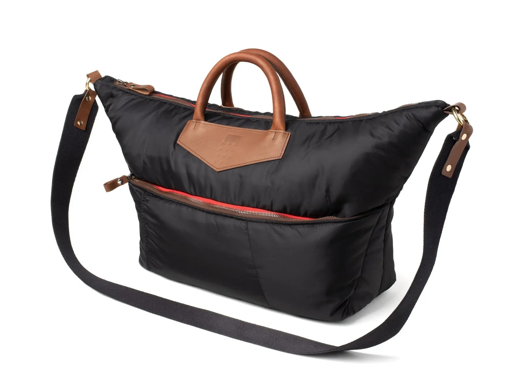Black bag with brown handles and strap on a white background