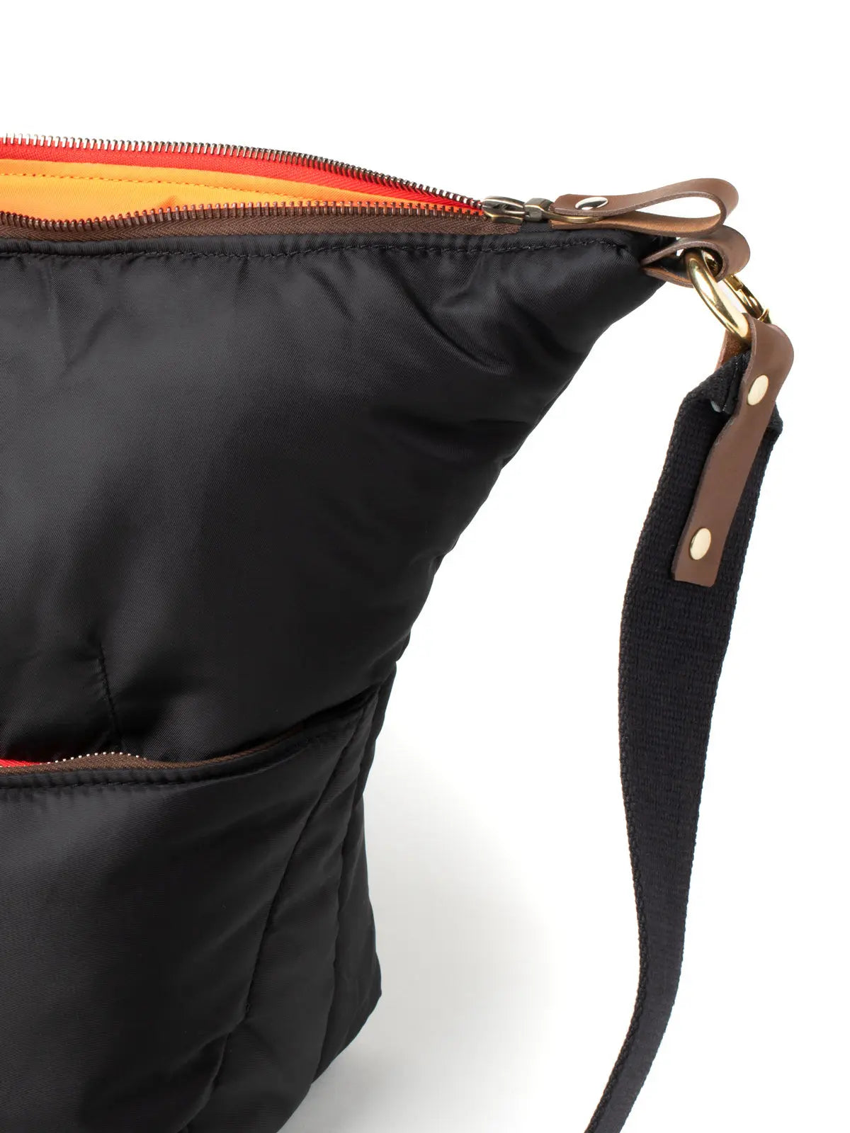 Black bag with a strap and zipper detail on a white background