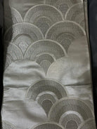 Silk scarf with geometric pattern on a plain background