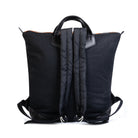 Black backpack with a rain cover on a white background