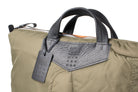 Olive Khaki bag with a black tag on a white background
