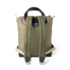Backpack with quilted green back panel on a white background
