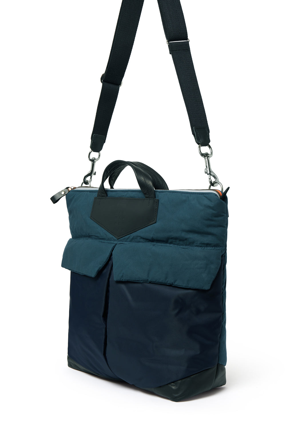 Navy backpack with a black strap on a white background