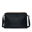 Black shoulder bag with orange interior lining on a white background