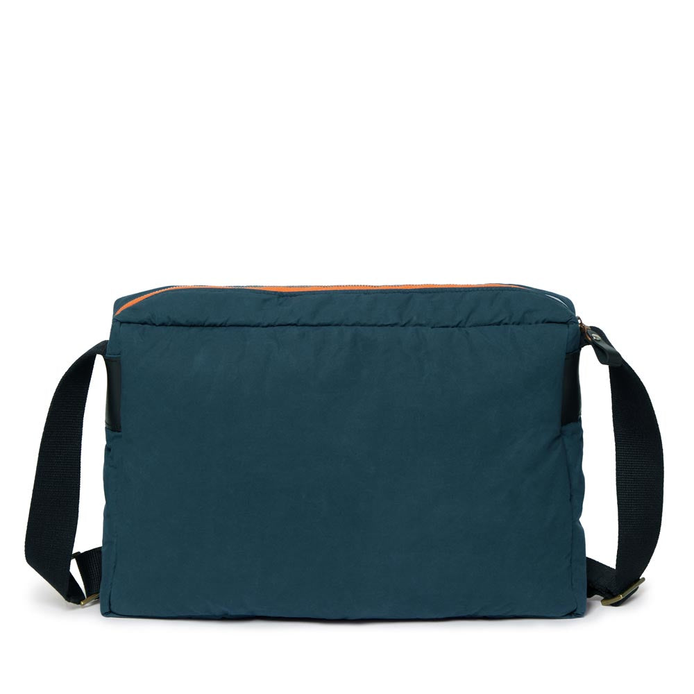 Blue messenger bag with black straps on a white background