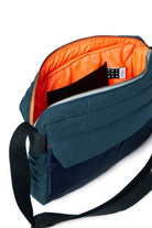Blue shoulder bag with orange interior on a white background