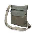 Olive crossbody bag with a strap on a white background
