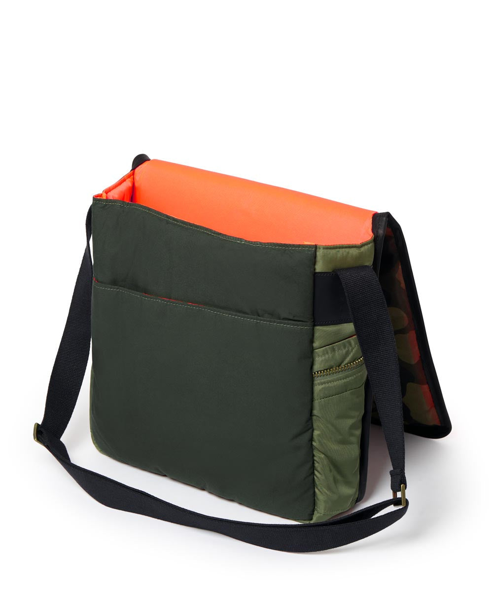 Multicolored bag with Olive, orange, and black sections on a white background