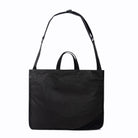 Black medium size tote bag with strap on white background