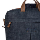 Dark denim backpack with brown leather straps on a white background