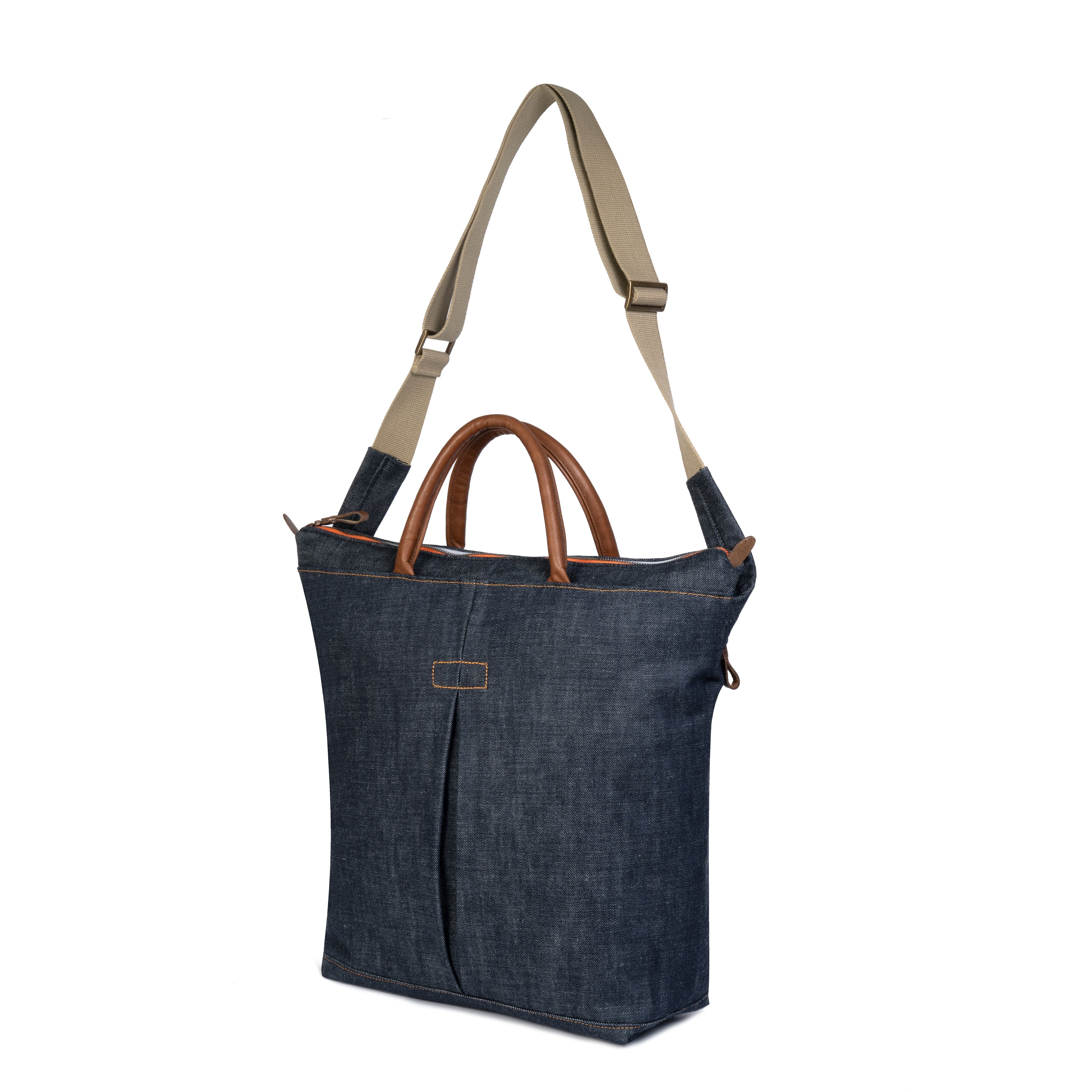 Blue denim tote bag with brown handles and beige strap on a white background