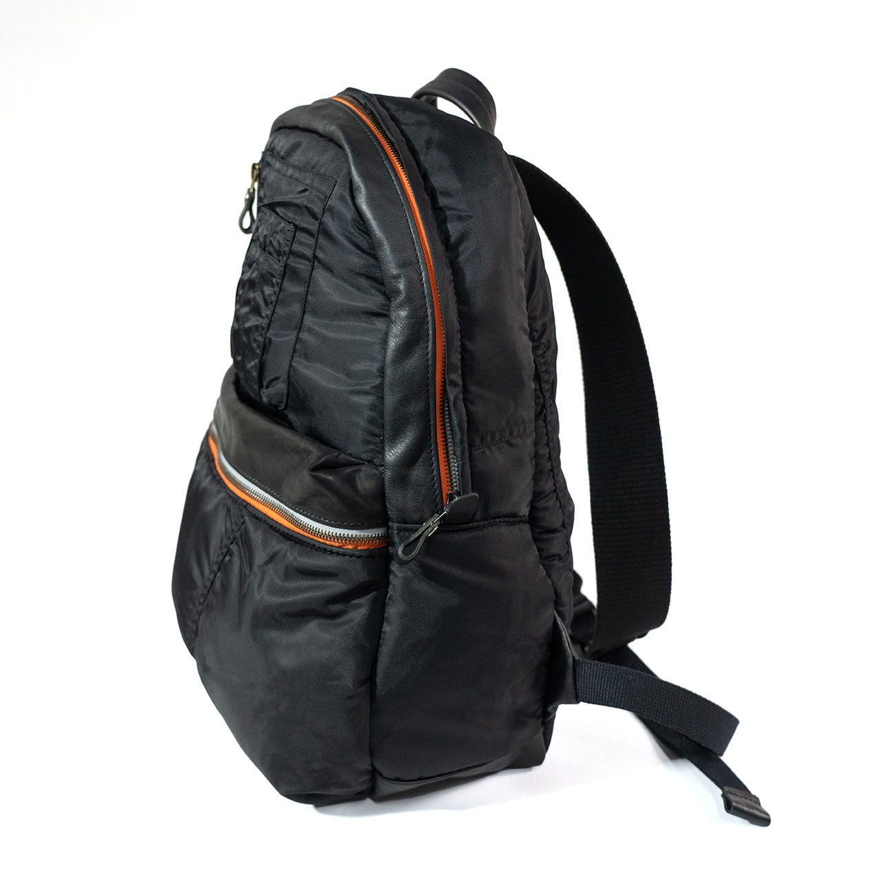 Black backpack with orange zippers on a white background