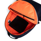 Backpack with orange interior compartment and black tablet inside on a white background