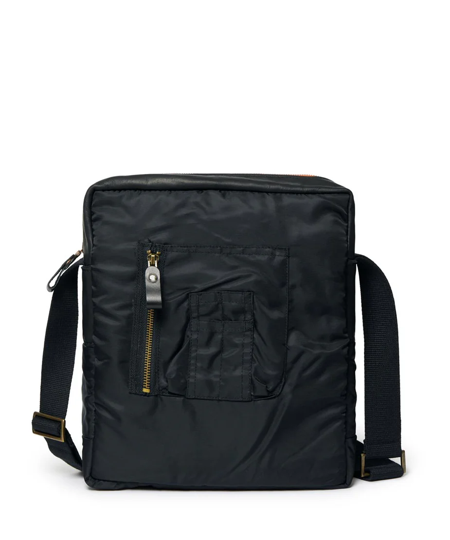 Black backpack with a strap and a  front pocket and zipper on a white background