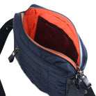 Navy blue shoulder bag with orange interior on a white background