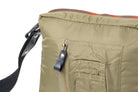 Close-up of an Olive bag with a strap and zipper detail on a white background