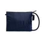 Navy blue pouch with a braided handle on a white background