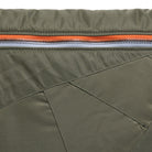 Close-up of a green jacket with an orange zipper