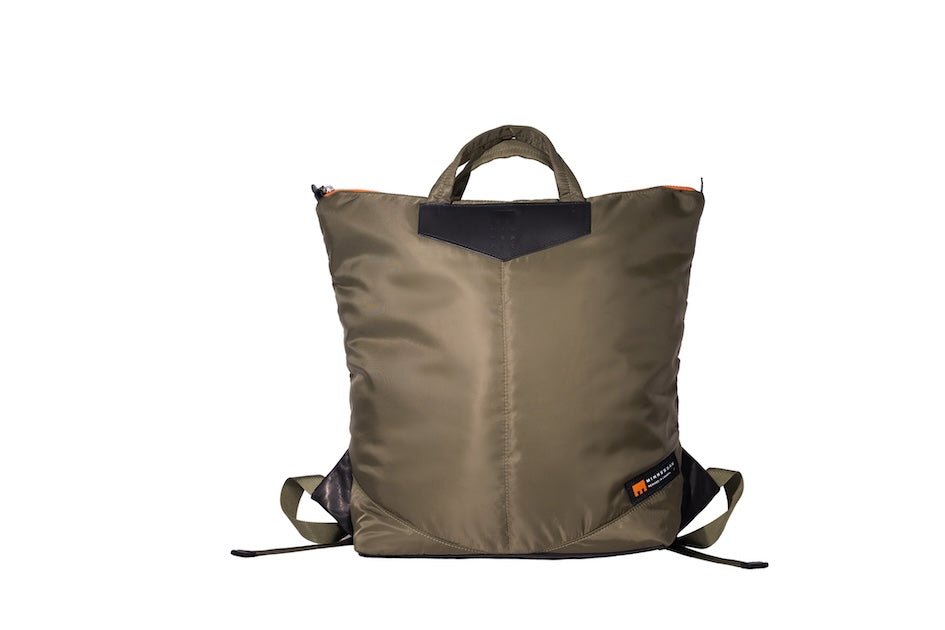 Olive Back Up/26 sustainable backpack handmade from repurposed MA-1 flight jacket material with quilted shoulder straps and leather details.