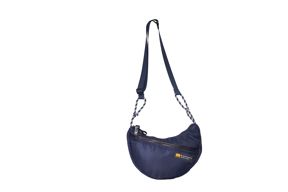 Navy Boat Small sustainable crescent crossbody bag handmade from repurposed MA-1 flight jacket material with adjustable shoulder strap and front zip pocket. Front