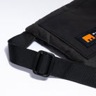 Small cross body bag in black showing strap detail and Minnessak logo on white background