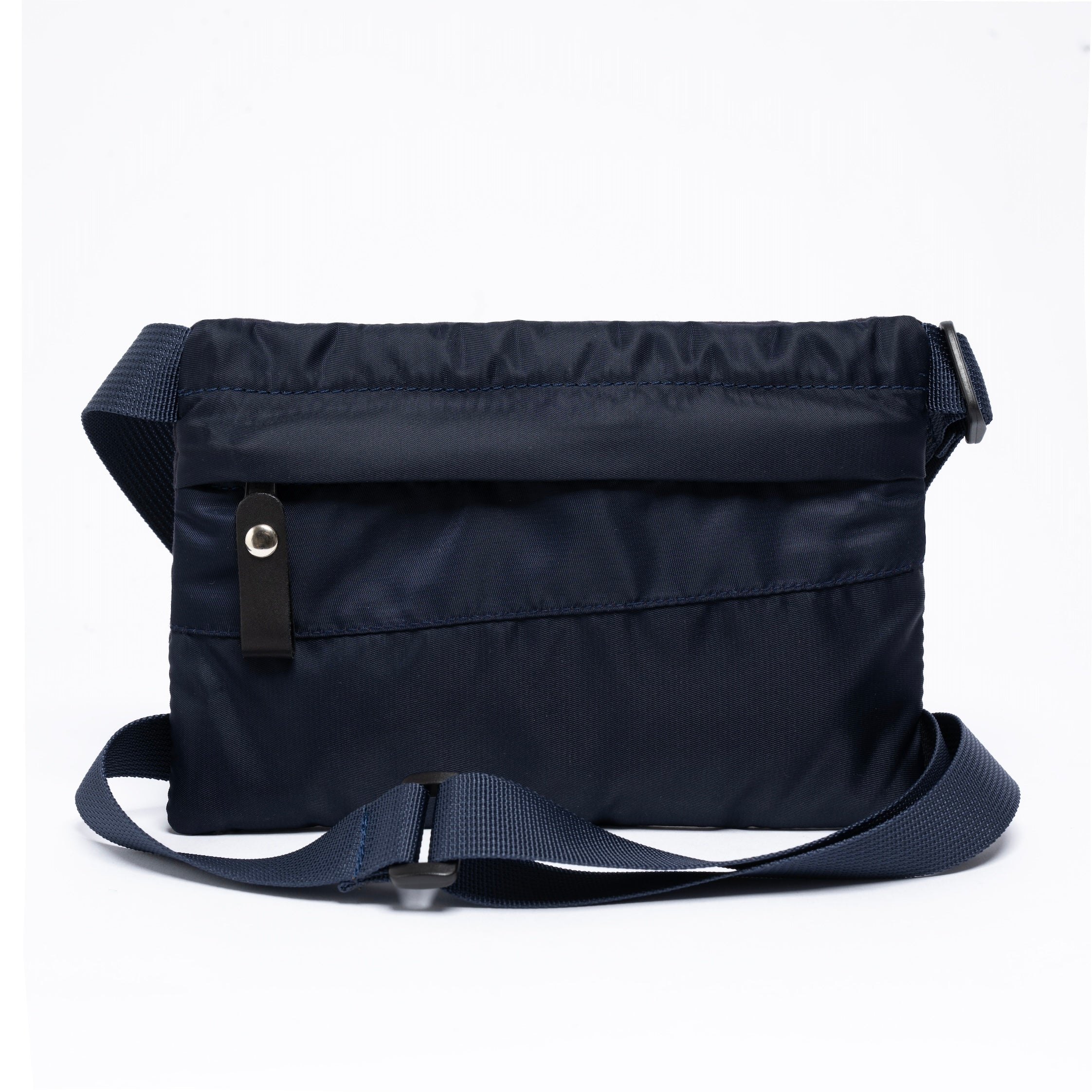 Small cross body bag in navy on a white background