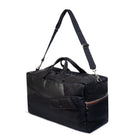Black duffel bag with a strap on a white background