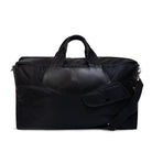 Black duffel bag with leather handle on a white background