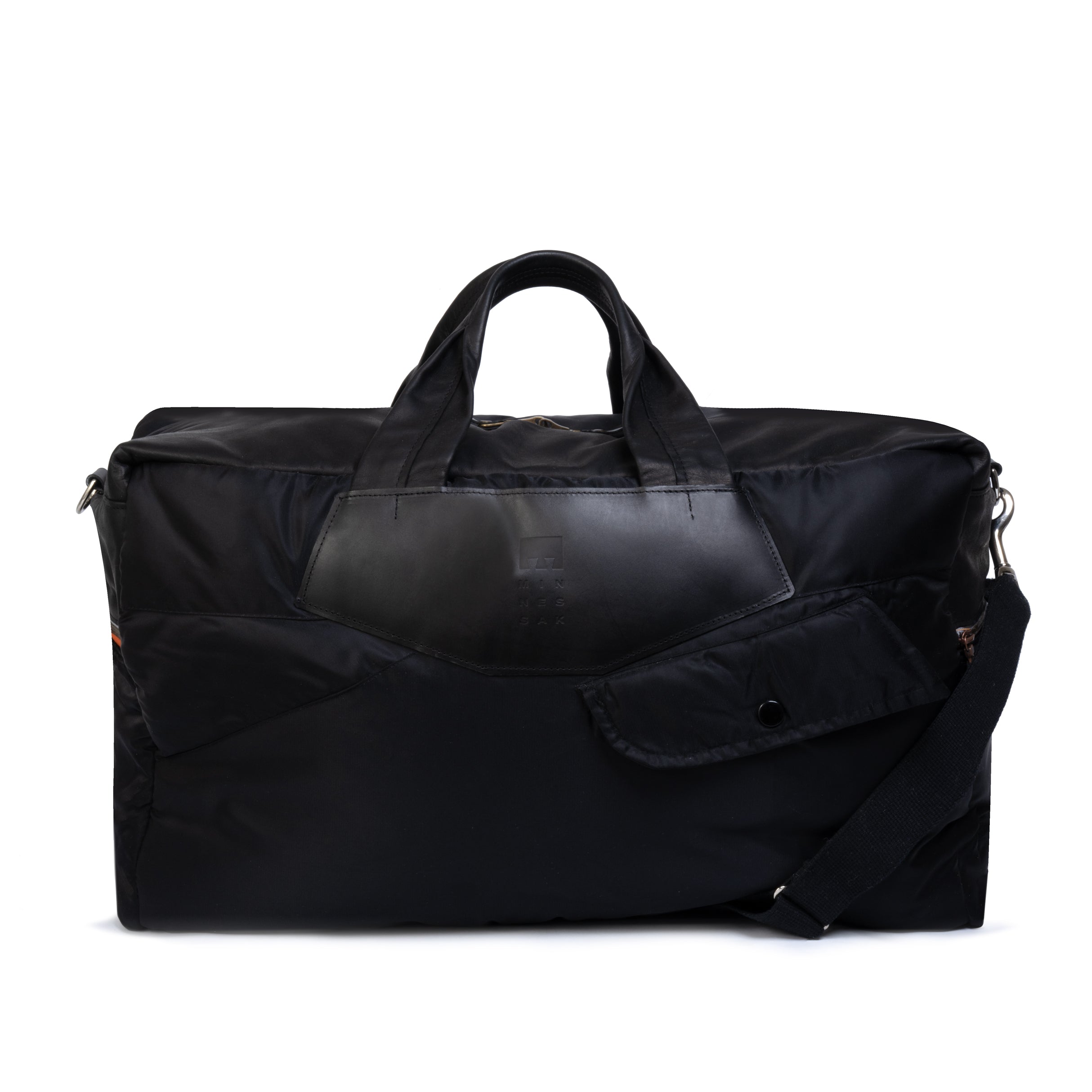 Black duffel bag with leather handle on a white background