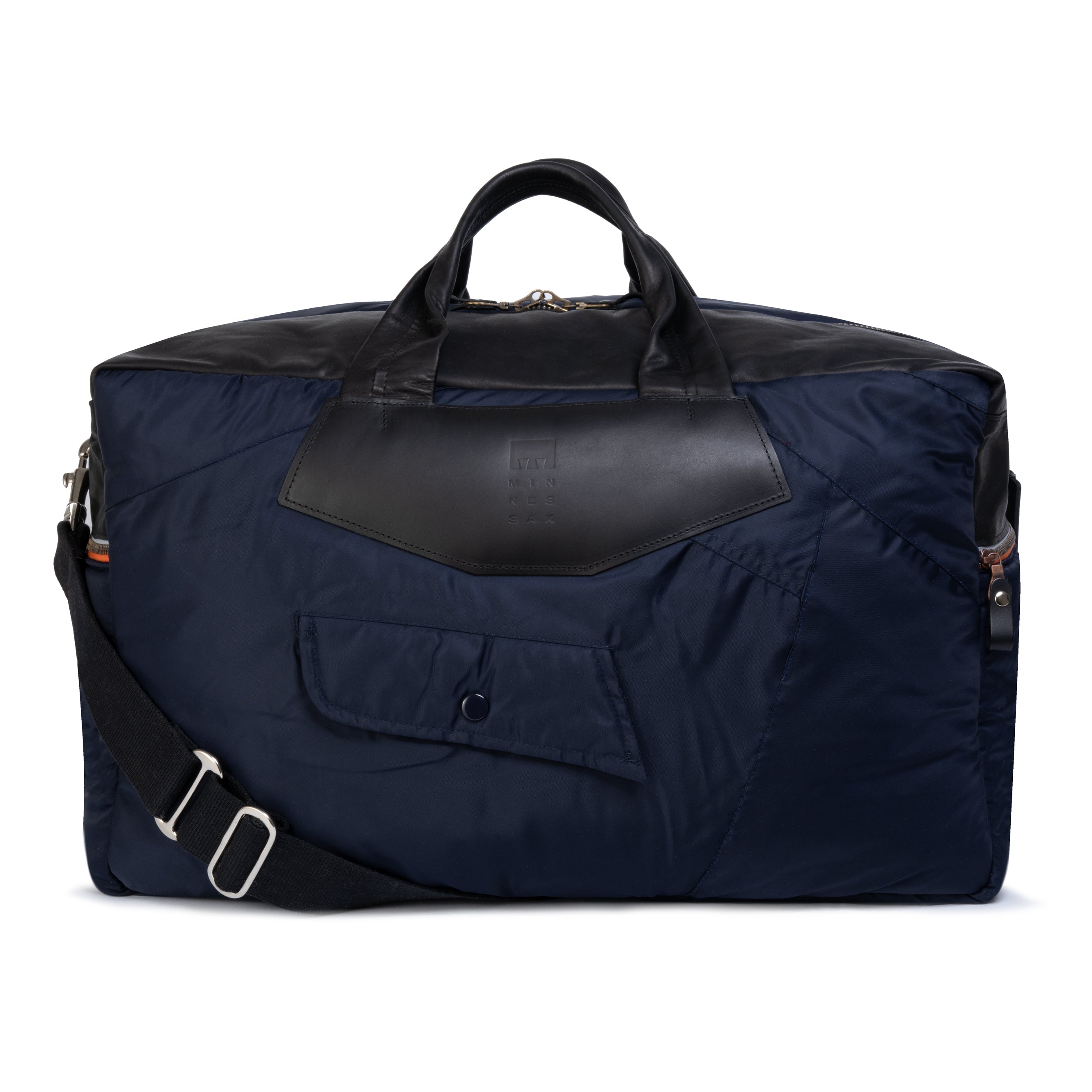 Navy blue duffel bag with black leather accents on a white background