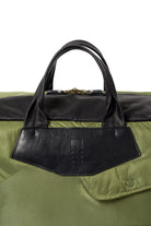 Olive bag with black handle on a white background