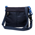 Black shoulder bag with blue chain straps on a white background