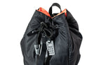 Black backpack with orange accents and a lock on a white background