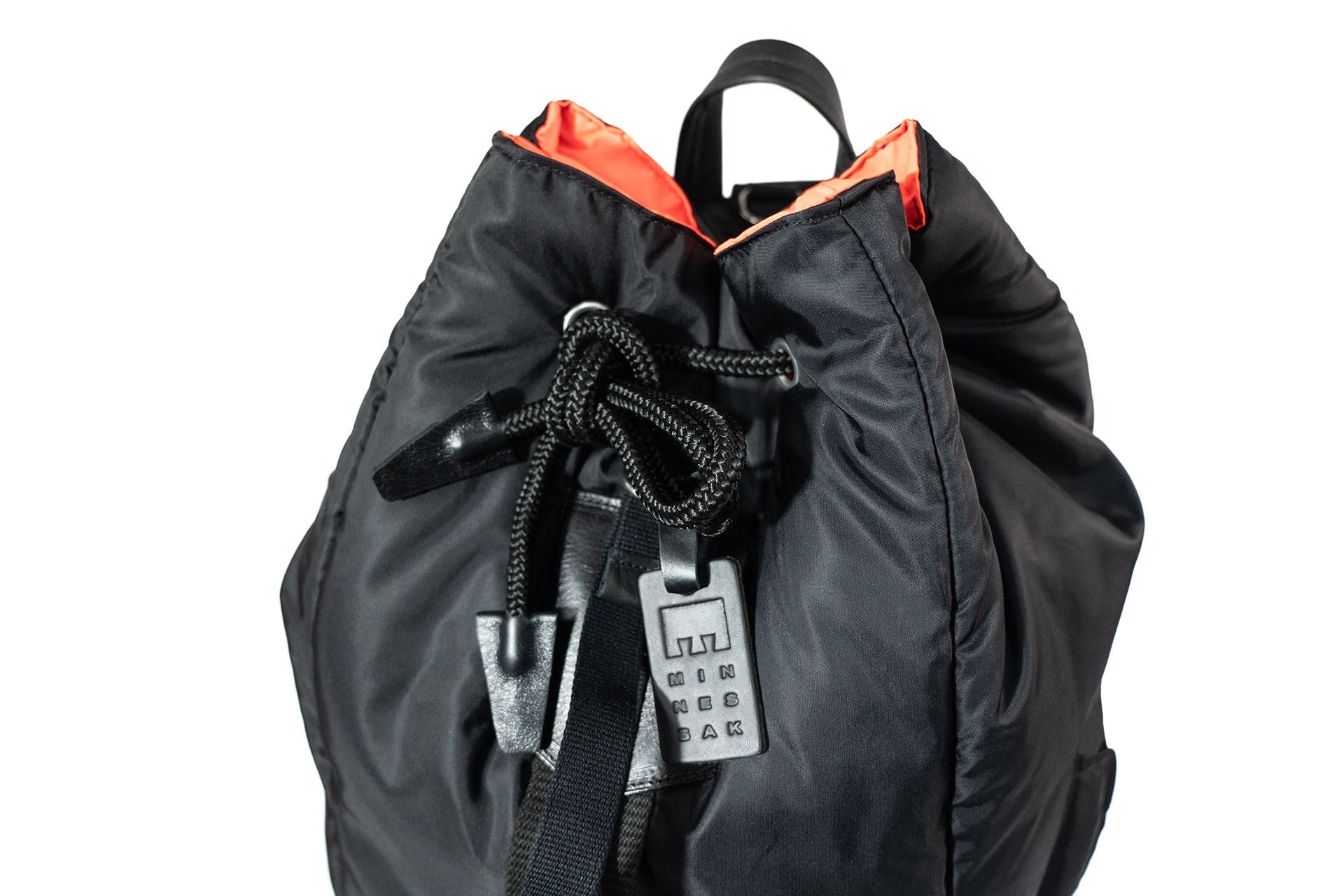 Black backpack with orange accents and a lock on a white background