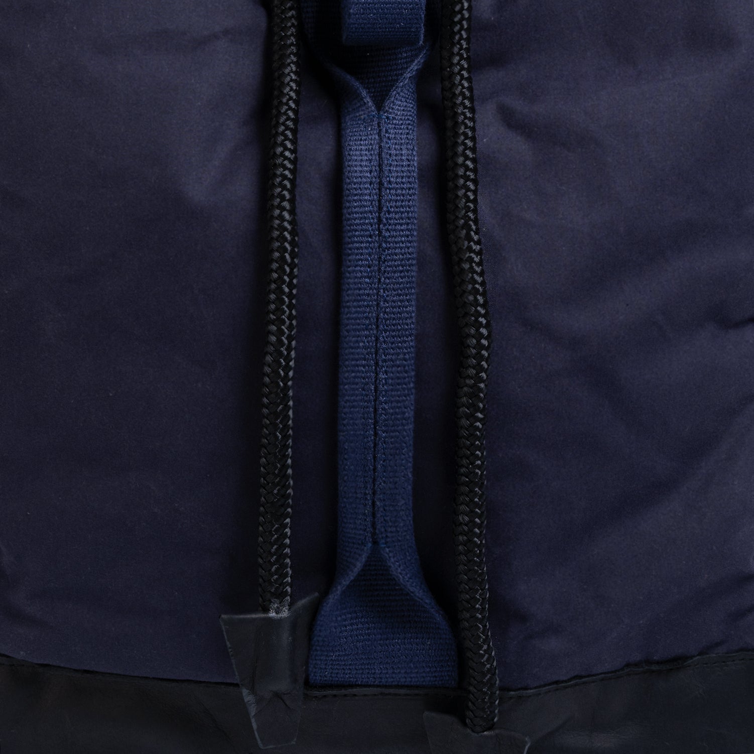 Close-up of a navy blue jacket with a zipper