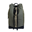 Olive backpack with a black handle on a white background