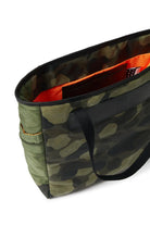 Camouflage-patterned bag with a black handle on a white background