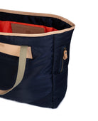 Navy tote bag with olive handles and trim on a white background
