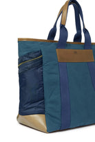 Navy Blue and brown tote bag with a visible brand label on a white background