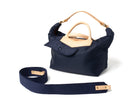 Navy blue handbag with beige accents on a white background