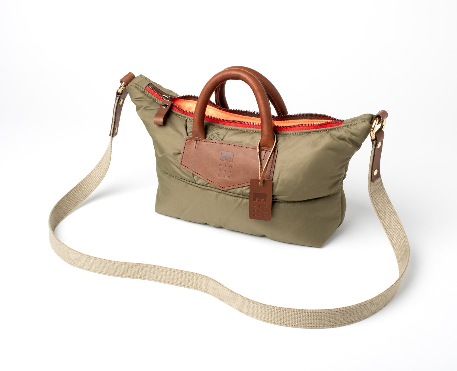 Olive handbag with brown leather accents with strap on a white background