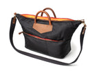 Black bag with brown handles and orange interior on a white background