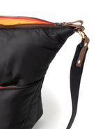 Black bag with a strap and zipper detail on a white background